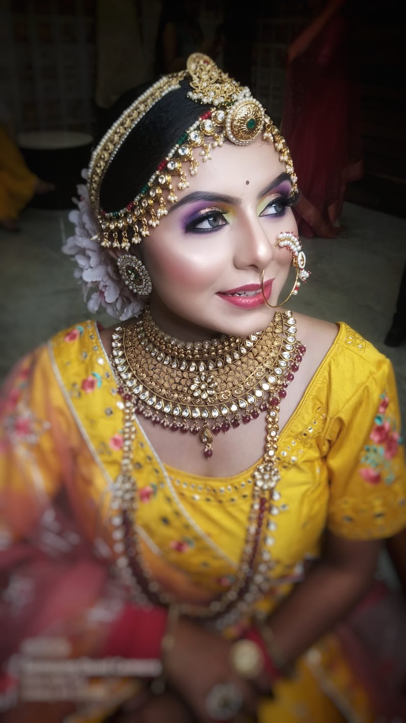 Bridal updo hairstyle being styled for wedding in Bemetara